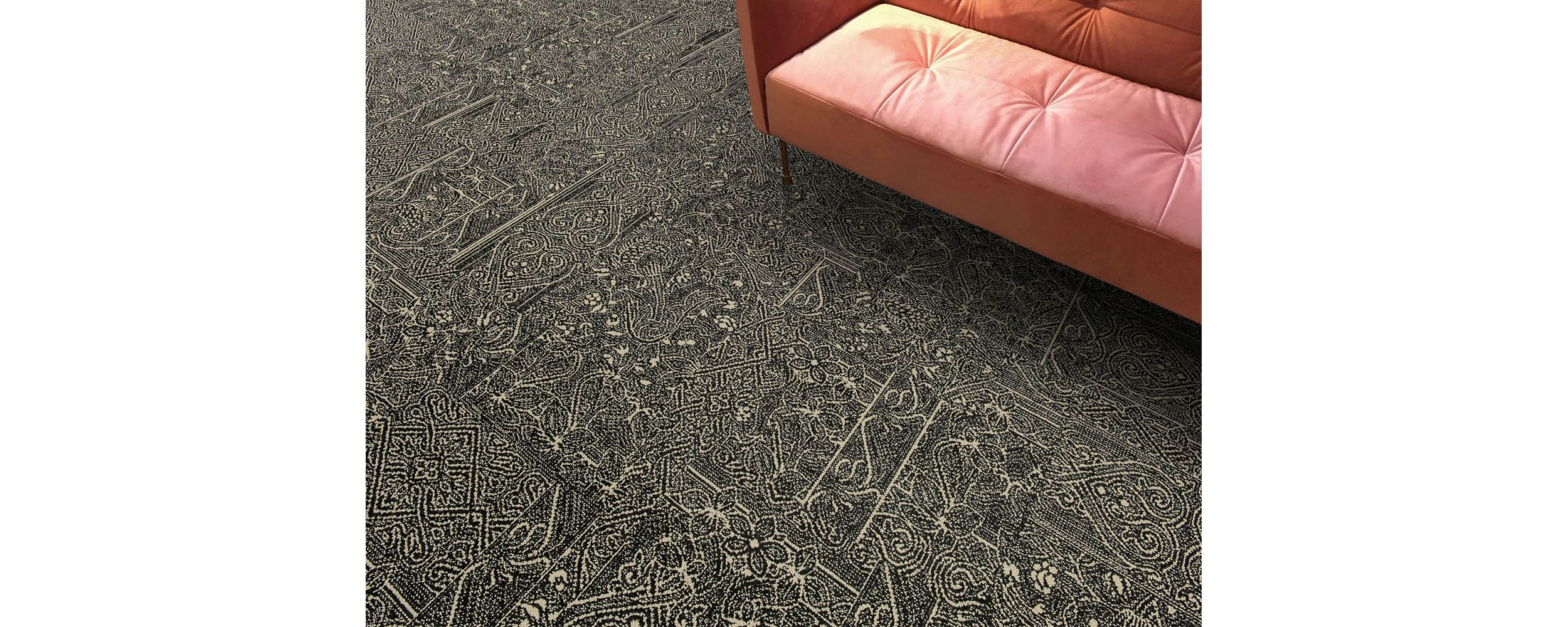 Detail of Interface DL924 carpet tile with salmon colored sofa image number 4